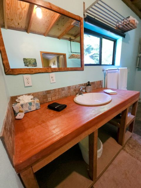 Spacious custom-built cement & local hardwoods vanity.