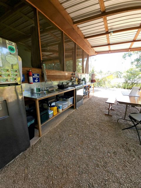 Shared outdoor kitchen - includes 6 burner stovetop, full-size frig/freezer and double sink with plenty of counter space and a charcoal grill!