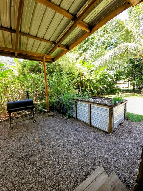 Shared outdoor kitchen - includes 6 burner stovetop, full-size frig/freezer and double sink with plenty of counter space and a charcoal grill!  The raised bed has seasonal veggies & herbs for our guests' use.