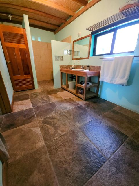 Spacious bathroom with private toilet area, walk-in shower and huge custom-built vanity