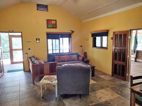 Living room with 2 twin day-beds & rocker/recliner, large live-edge custom made coffee table, desk & chair.  
