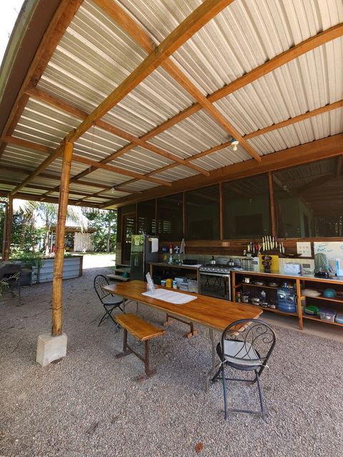 Shared outdoor kitchen - includes 6 burner stovetop, full-size frig/freezer and double sink with plenty of counter space and a charcoal grill!