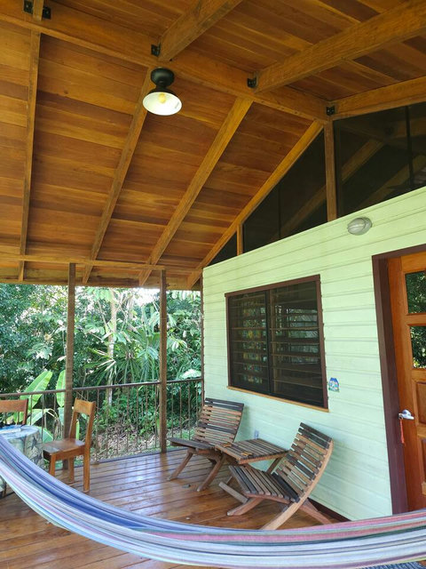 Spacious deck, with seating for two, plus dining table and hammock