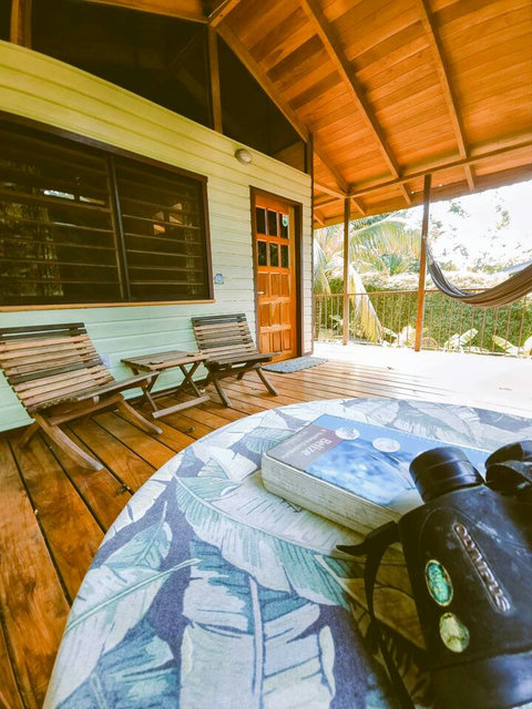 Spacious deck, with seating for two, plus dining table and hammock