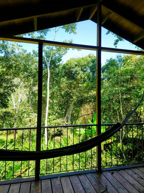 Spacious deck, with seating for two, plus dining table and hammock
