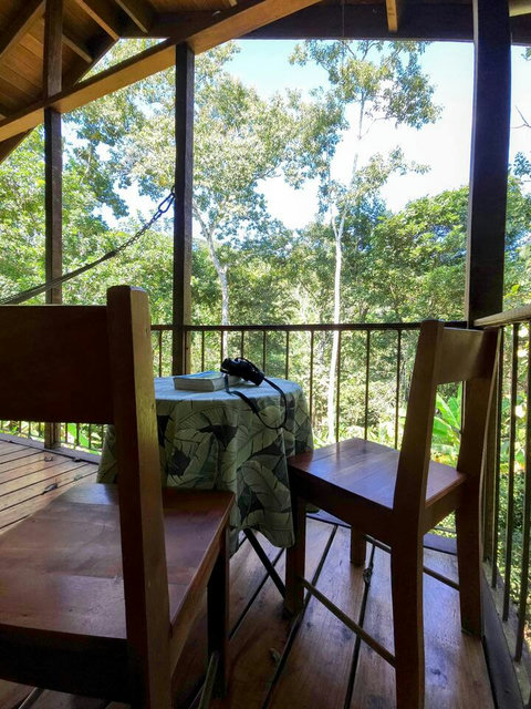 Spacious deck, with seating for two, plus dining table and hammock