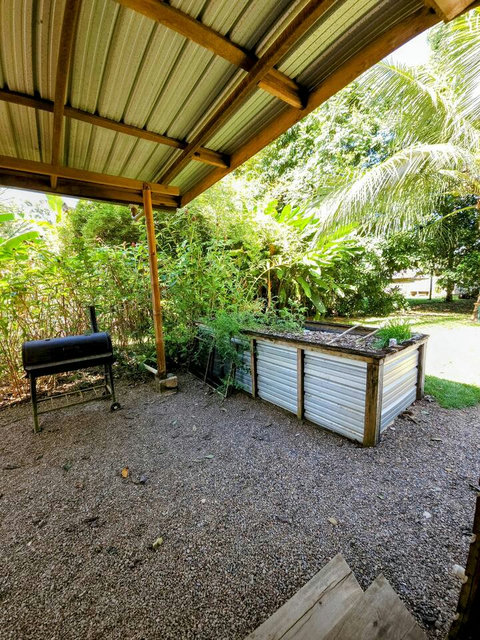 Shared outdoor kitchen - includes 6 burner stovetop, full-size frig/freezer and double sink with plenty of counter space and a charcoal grill!  The raised bed has seasonal veggies & herbs for our guests' use.