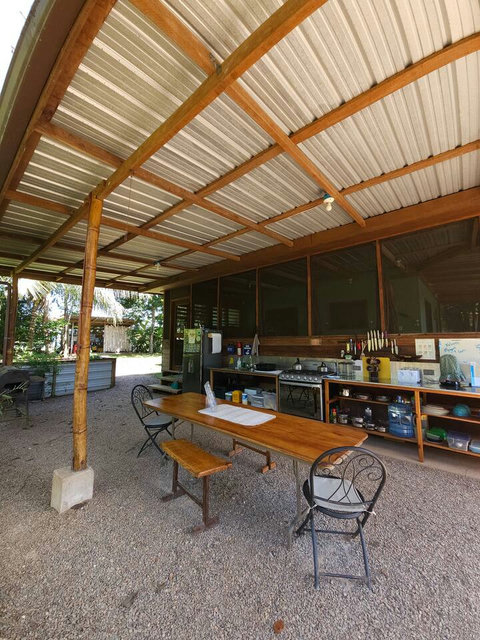 Shared outdoor kitchen - includes 6 burner stovetop, full-size frig/freezer and double sink with plenty of counter space and a charcoal grill!
