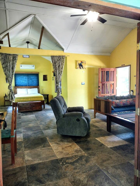 Living room with view of bedroom.  Privacy curtains separate bedroom from living room if needed.