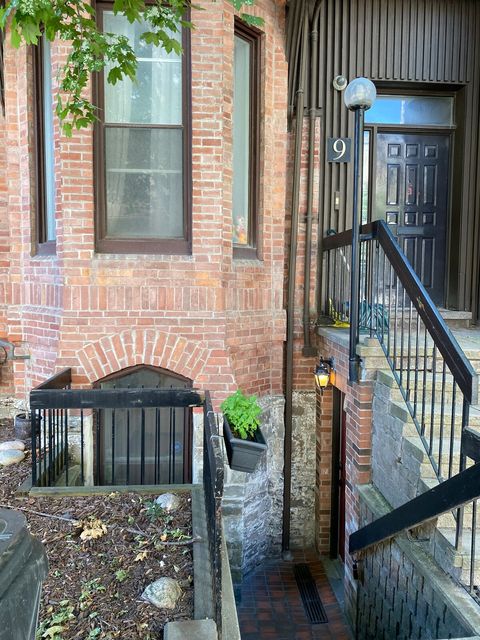 Enter by going down the stairs.