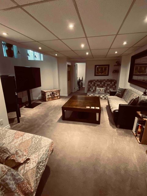 Sofa bed and floor mattress opposite ends of the room 