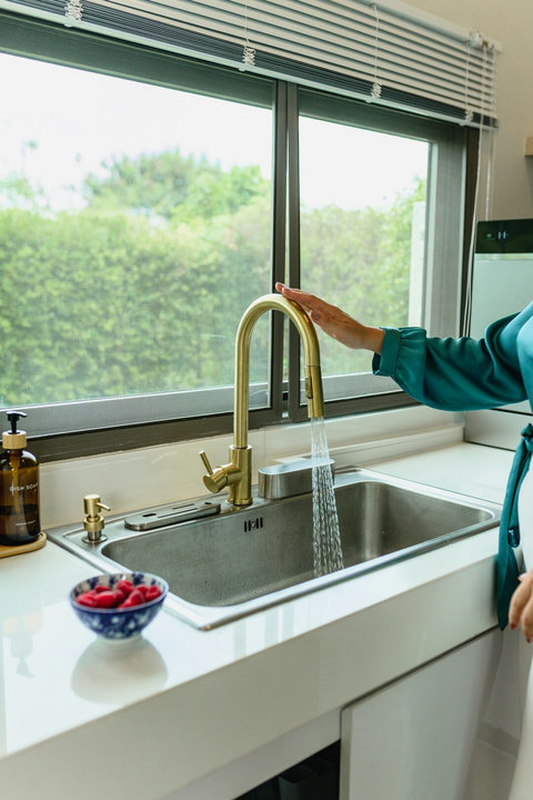 Smart touch kitchen tap with built-in sensor for convenient use.