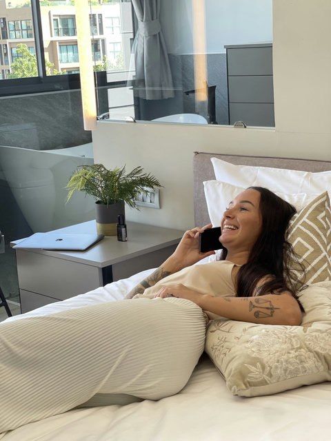 Happy guest appreciating the comfort of Master Bedroom 1