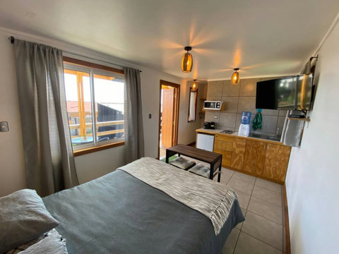 Smart TV, Kitchennette with botle of drinking water