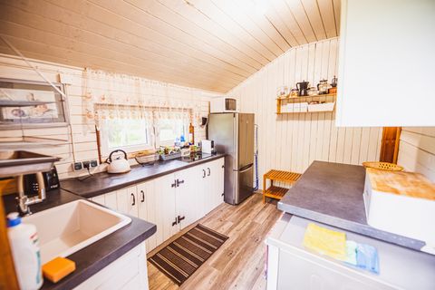 Kitchen with top stove fridge, espresso machine, dishwasher
