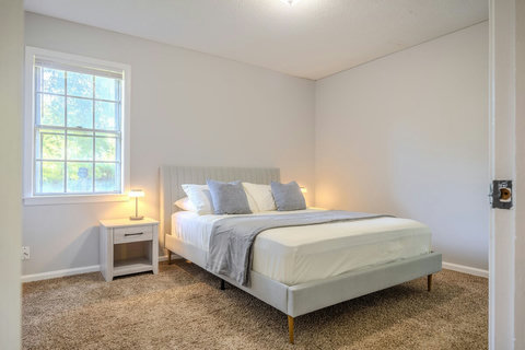 Bedroom 2 features a cozy queen bed, soft carpet, touch-control bedside lamps, and a roomy closet for your belongings. Designed for comfort and convenience, it's perfect for guests, family, or traveling professionals.