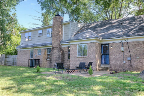 Enjoy a shaded front porch with rocking chairs, a spacious backyard with a fire pit grill, and outdoor dining furniture. Relax or entertain under four towering 100-year-old oak trees that provide beauty and natural shade.