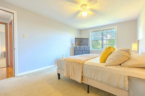Bedroom 3 offers a queen bed, smart TV, dresser, closet, and soft carpet for a cozy, functional stay. Ideal for relaxing after work or streaming your favorite shows, with plenty of space to unpack and settle in.