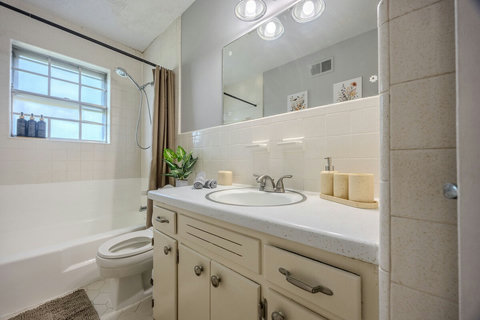 On the 1st floor, Bathroom 2 includes a shower/tub combo, towels + toiletries, and tasteful décor. It also comes with a bidet on the toilet so you can go about your day worry free. Perfect for guests or quick access from the main living areas.