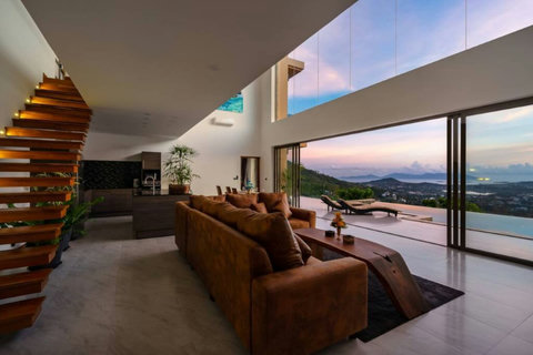 "Lounge Luxe: Our living room lounge area, with a staircase leading to the upper floor, is the heart of comfort and style."