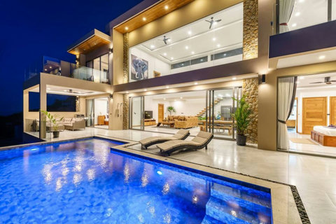 "Poolside by Night: The illuminated pool and villa lighting create a magical nighttime atmosphere."