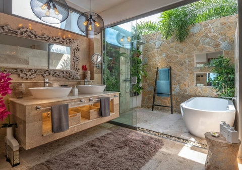 "Luxurious bathroom with fine design elements, an outdoor tub for stargazing or sky watching, and twin sinks—ideal for couples seeking elegance and convenience."
