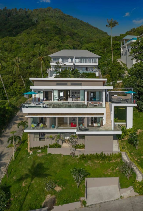 "Another stunning aerial shot of our villa's front, showcasing the grandeur and tranquil location, inviting you to a perfect getaway."