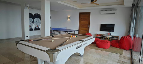 Our versatile game room is equipped with a pool table, ping pong table, and a cozy kids' lounge—perfect for guests of all ages!"