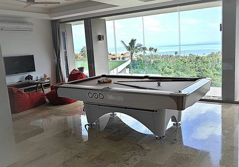 "Rack up the balls and enjoy a game on our pool table, all while soaking in the spectacular scenery from the windows."