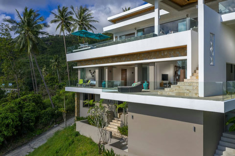 "A bird's eye view of paradise: our drone captures the stunning facade of the villa, setting the stage for your luxurious escape