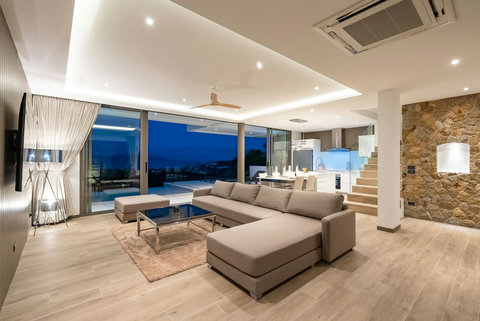 "Spacious living area seamlessly blends living, dining, and kitchen spaces for a perfect family gathering."