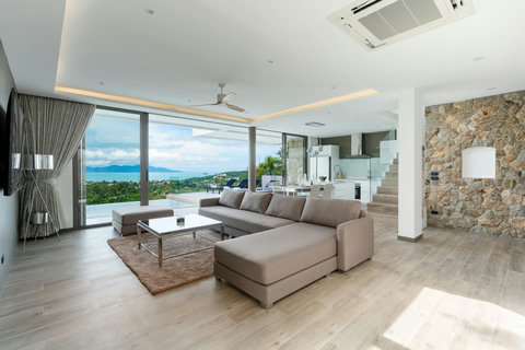 "Cozy up in our living room and gaze out at the distant Koh Phangan."