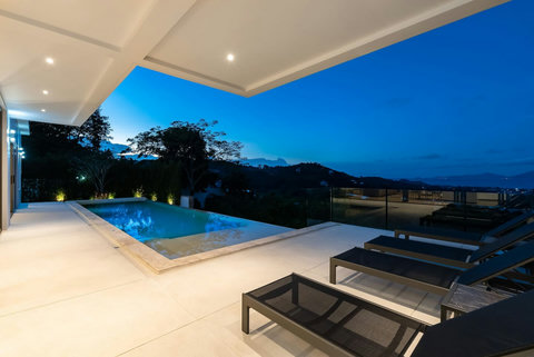"Evening serenity as the valley lights up under the twilight sky."