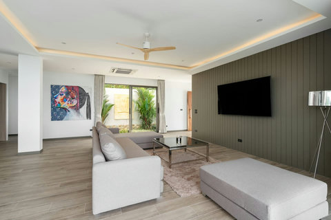 "Relax in our living room featuring a smart TV and luxurious comforts."
