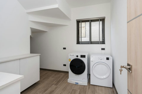 "Convenience meets functionality in our utility area equipped with a washer and dryer—perfect for long stays."
