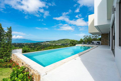 "Panoramic views of the valley, our shimmering pool, and the vast sea beyond."