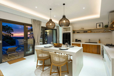 Open-plan kitchen and dining area with sunset views