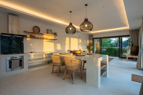 Spacious living area with designer pendant lighting and garden access