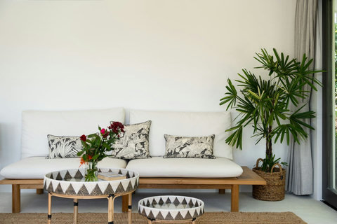 Outdoor lounge daybed surrounded by tropical greenery