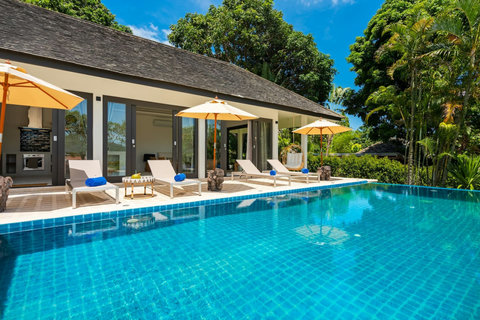 Crystal-clear pool surrounded by lush tropical palms