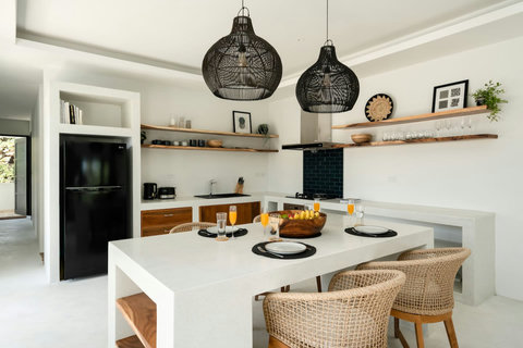 Stylish dining area with wicker pendant lights