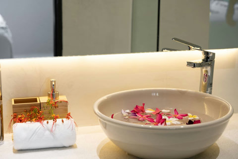 Romantic flower petal bath with candlelight setting