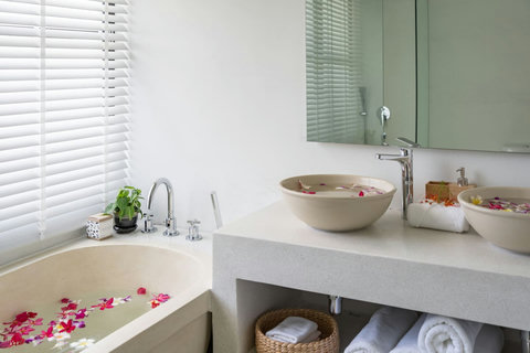 Modern bathroom with stone finish and warm lighting