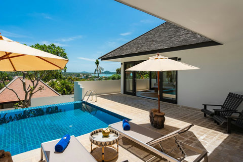 Covered outdoor lounge with ceiling fan and landscape views
