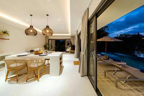 Elegant dining area with pendant lighting and tropical decor