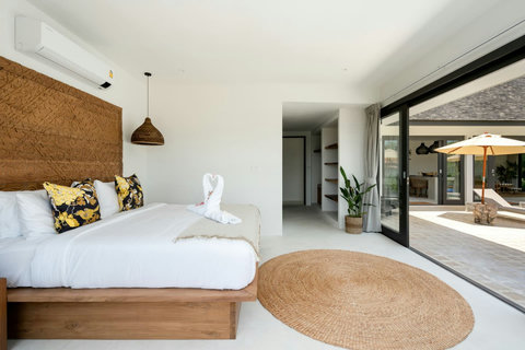 Bright bedroom with stylish headboard and white linens