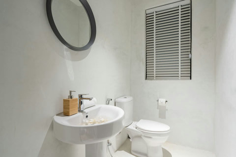 Bright and modern bathroom with shuttered window