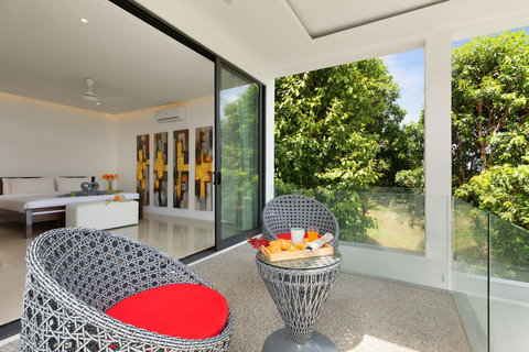 Private balcony seating area with garden views - perfect spot for morning coffee or evening relaxation
