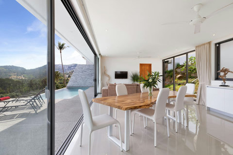 Dining room with panoramic sea views and direct terrace access - accommodates 8 guests comfortably