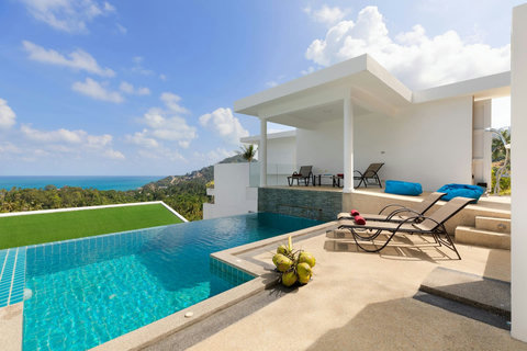 Private infinity pool terrace with lounge chairs and breathtaking elevated sea views over the Gulf of Thailand